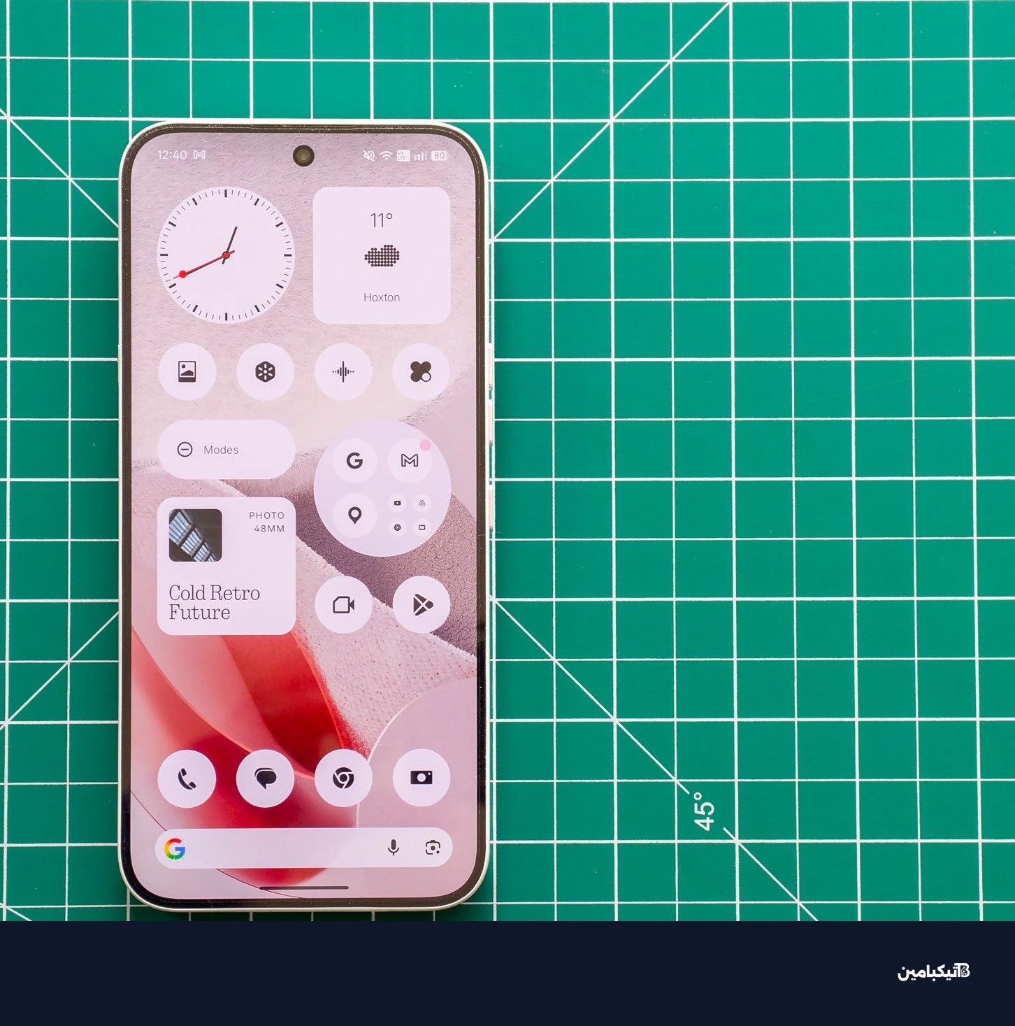 صورة لهاتف Nothing Phone 4A Pro على حصيرة خضراء تظهر الشاشة الرئيسية