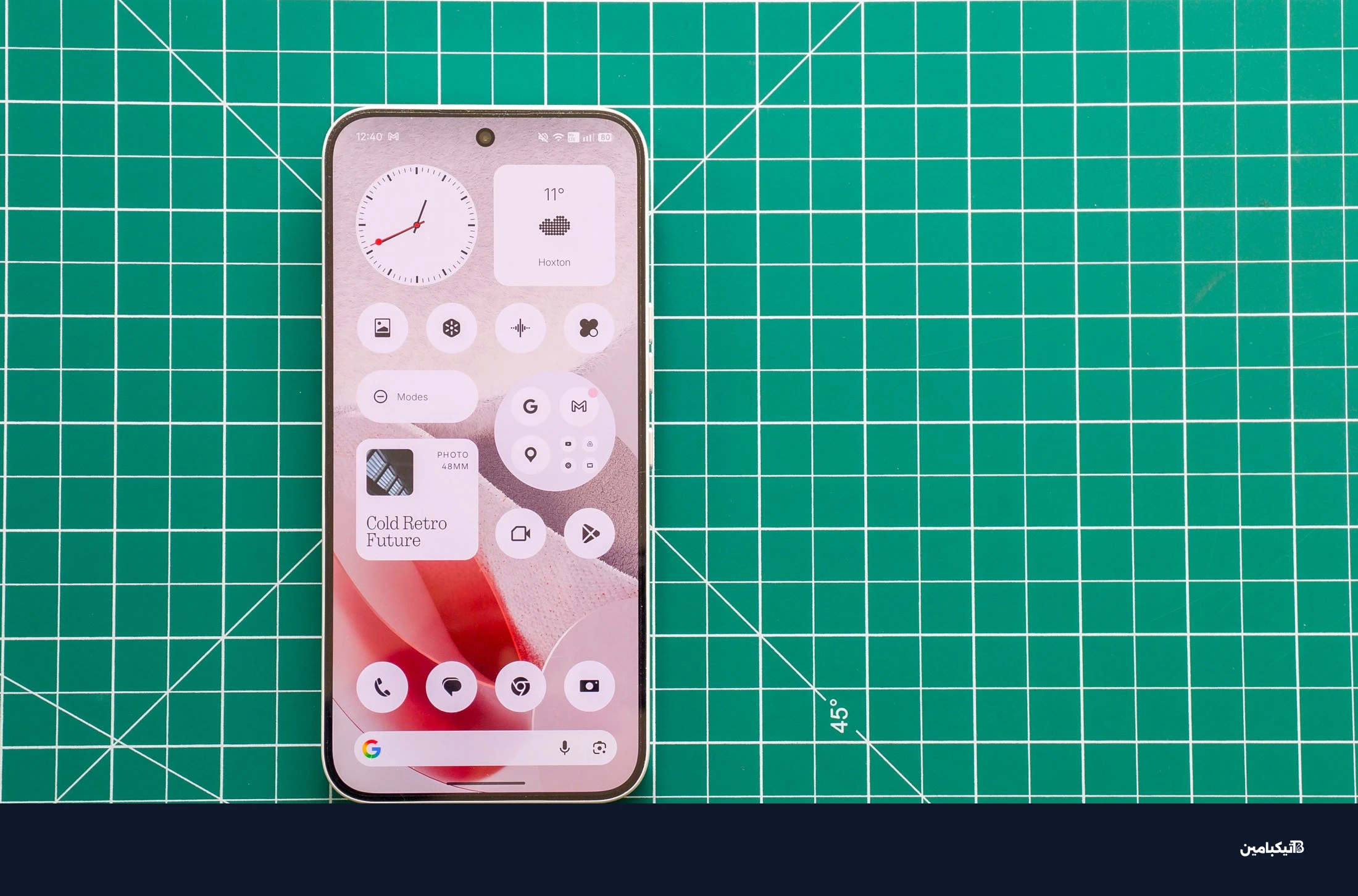 صورة لهاتف Nothing Phone 4A Pro على حصيرة خضراء تظهر الشاشة الرئيسية